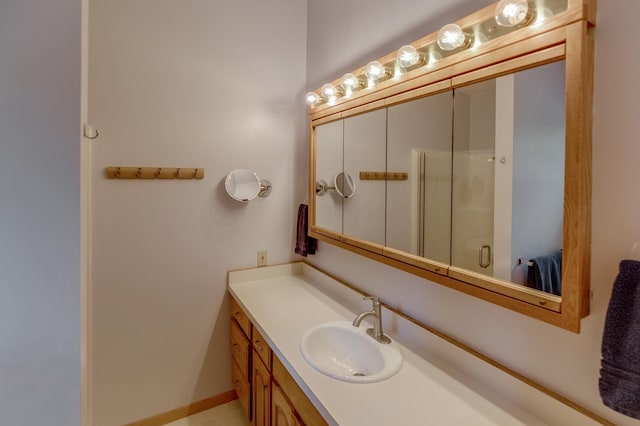 bathroom featuring vanity and a shower stall