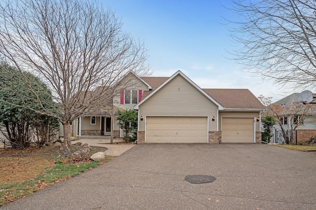 2970 Western Ave N, Roseville, MN 55113 - traditional-style house featuring a garage, asphalt driveway, brick siding, and a porch