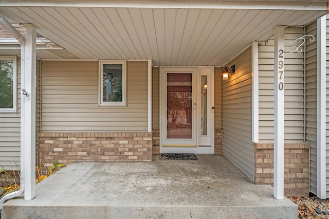 2970 Western Ave N, Roseville, MN 55113 - view of exterior entry featuring brick siding, a porch, and an attached carport