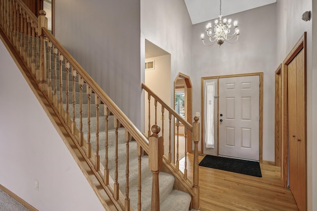 2970 Western Ave N, Roseville, MN 55113 - foyer featuring high vaulted ceiling, wood finished floors, baseboards, a chandelier, and stairway