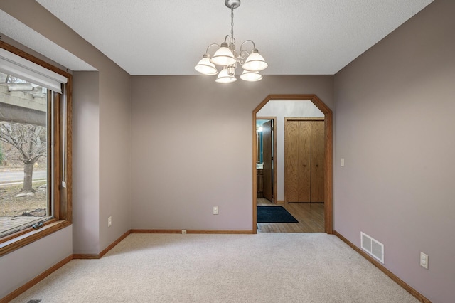 2970 Western Ave N, Roseville, MN 55113 - spare room with carpet floors, a chandelier, and baseboards