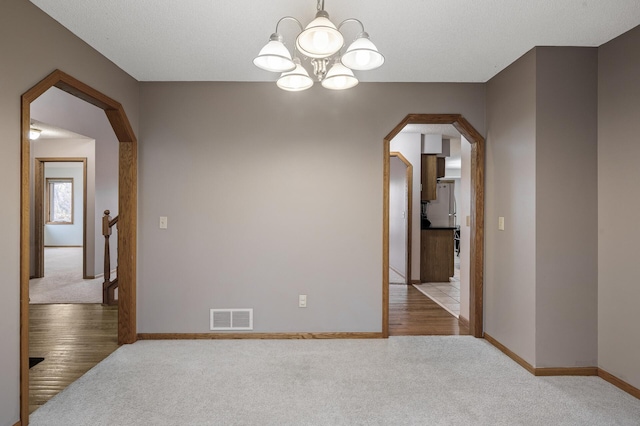 2970 Western Ave N, Roseville, MN 55113 - unfurnished room with arched walkways, carpet flooring, a chandelier, and baseboards