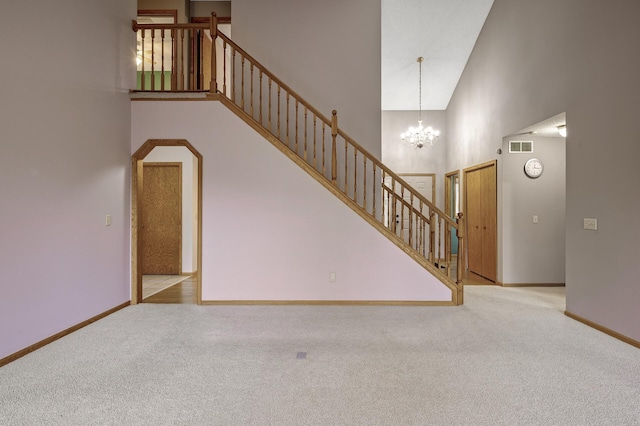 2970 Western Ave N, Roseville, MN 55113 - unfurnished living room featuring a towering ceiling, carpet, a chandelier, stairs, and baseboards