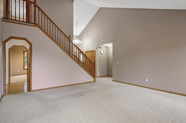 2970 Western Ave N, Roseville, MN 55113 - unfurnished living room featuring carpet floors, high vaulted ceiling, stairs, baseboards, and a chandelier