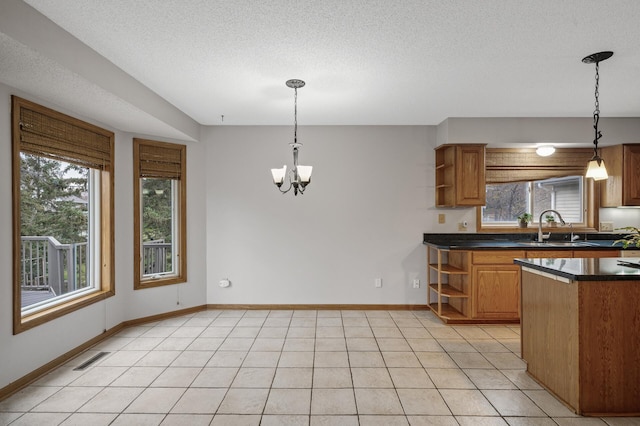 2970 Western Ave N, Roseville, MN 55113 - kitchen featuring open shelves, a sink, dark countertops, brown cabinetry, and a chandelier