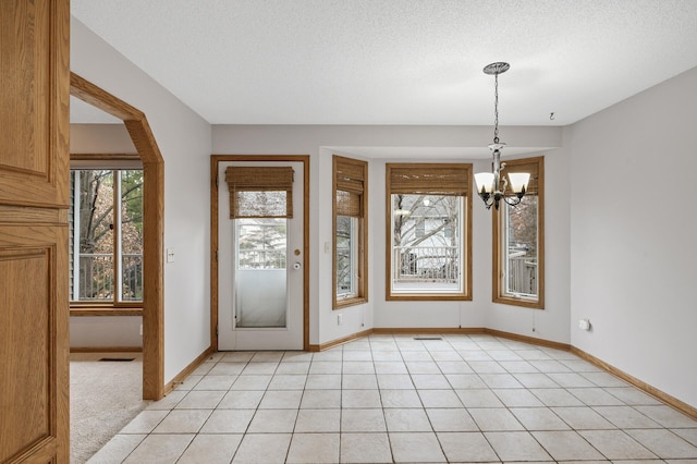 2970 Western Ave N, Roseville, MN 55113 - foyer with a chandelier, baseboards, a textured ceiling, and light tile patterned flooring