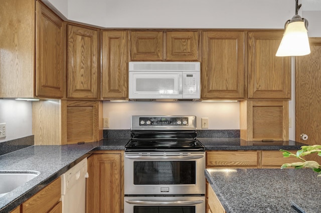 2970 Western Ave N, Roseville, MN 55113 - kitchen featuring white appliances, brown cabinetry, dark stone countertops, and decorative light fixtures