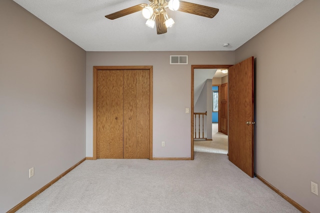 2970 Western Ave N, Roseville, MN 55113 - unfurnished bedroom featuring light carpet, a closet, baseboards, a ceiling fan, and a textured ceiling