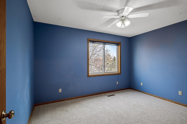 2970 Western Ave N, Roseville, MN 55113 - carpeted spare room featuring a textured ceiling, baseboards, and a ceiling fan