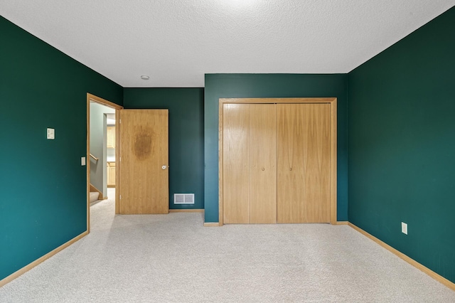 2970 Western Ave N, Roseville, MN 55113 - unfurnished bedroom featuring carpet flooring, a closet, baseboards, and a textured ceiling