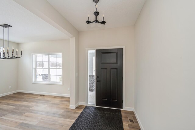 869 Greywood Blvd SW, Delano, MN 55328 - foyer entrance featuring a chandelier, light wood finished floors, and baseboards