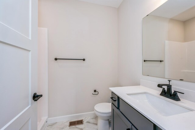 869 Greywood Blvd SW, Delano, MN 55328 - bathroom with marble finish flooring, toilet, vanity, baseboards, and a shower