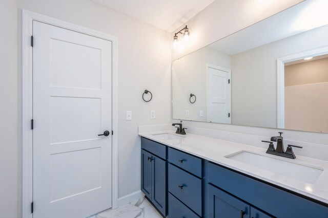 869 Greywood Blvd SW, Delano, MN 55328 - bathroom with marble finish floors, double vanity, and baseboards