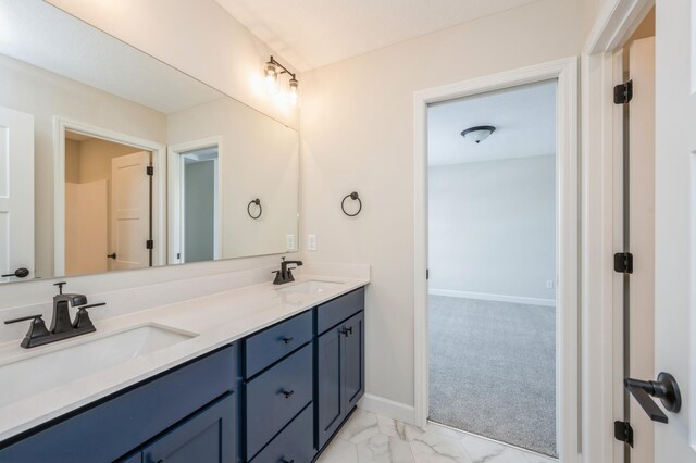 869 Greywood Blvd SW, Delano, MN 55328 - bathroom featuring marble finish flooring, double vanity, and baseboards