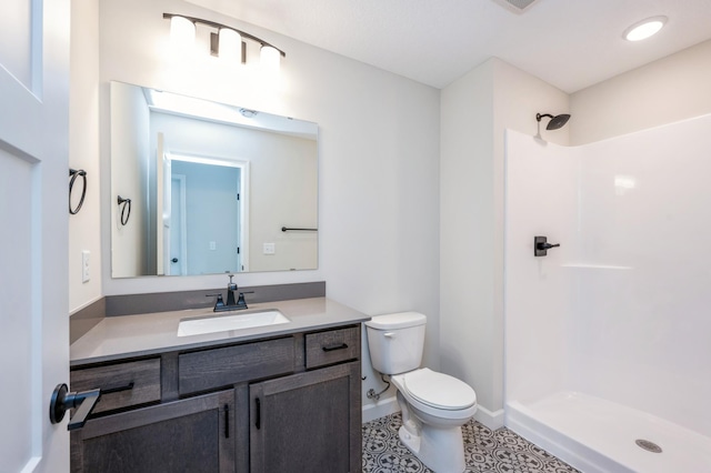 869 Greywood Blvd SW, Delano, MN 55328 - bathroom featuring toilet, a shower stall, vanity, baseboards, and tile patterned floors
