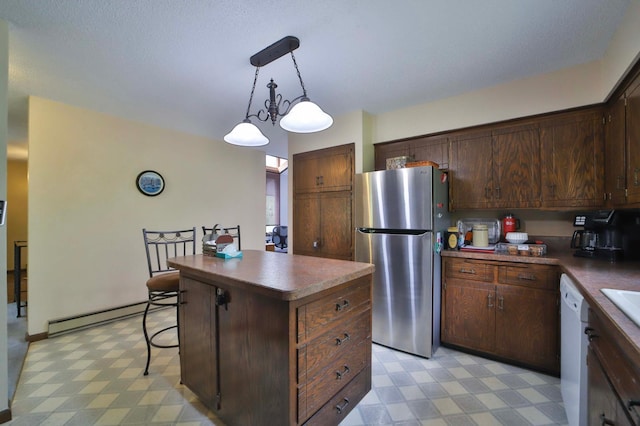 912 State 84 SW, Pine River, MN 56474 - kitchen featuring freestanding refrigerator, light floors, a baseboard heating unit, a center island, and hanging light fixtures