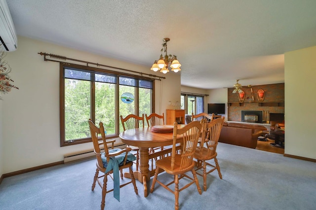 912 State 84 SW, Pine River, MN 56474 - carpeted dining area with a brick fireplace, a chandelier, a wall mounted air conditioner, baseboards, and a textured ceiling
