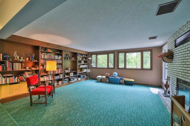 912 State 84 SW, Pine River, MN 56474 - sitting room with a textured ceiling, carpet, and a brick fireplace