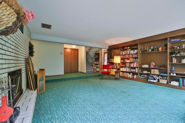 912 State 84 SW, Pine River, MN 56474 - living area featuring a fireplace, stairway, and carpet floors
