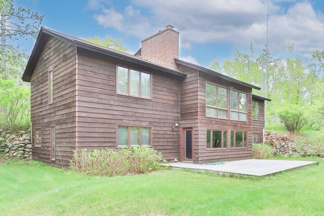 912 State 84 SW, Pine River, MN 56474 - rear view of house with a chimney and a yard