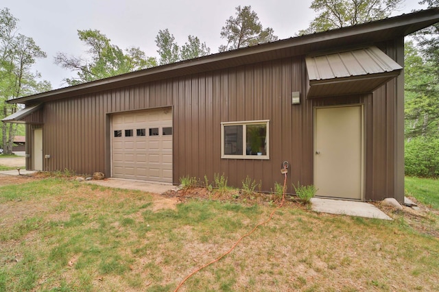 912 State 84 SW, Pine River, MN 56474 - view of property exterior featuring a lawn, metal roof, an outdoor structure, and a garage