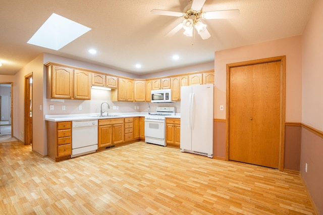 1930 Westridge Cir, Stillwater, MN 55082 - kitchen featuring white appliances, a sink, light wood-type flooring, a skylight, and recessed lighting