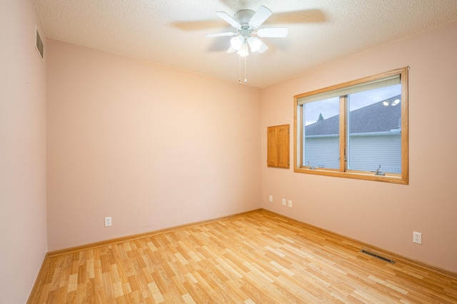 1930 Westridge Cir, Stillwater, MN 55082 - unfurnished room with wood finished floors, ceiling fan, baseboards, and a textured ceiling