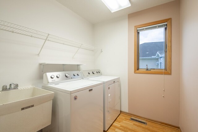 1930 Westridge Cir, Stillwater, MN 55082 - laundry room with independent washer and dryer, light wood-style flooring, and baseboards
