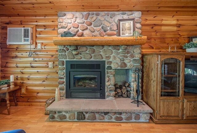 224 Norman Point Rd NW, Longville, MN 56655 - detailed view of wood finished floors, a wall mounted air conditioner, a fireplace, log walls, and wooden ceiling