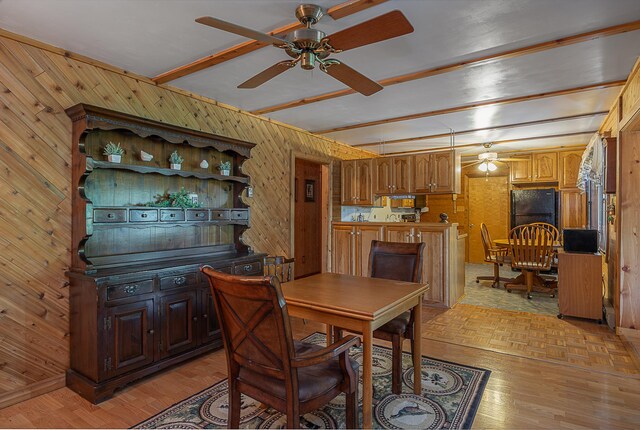 224 Norman Point Rd NW, Longville, MN 56655 - dining space featuring ceiling fan, wood walls, beamed ceiling, and parquet floors