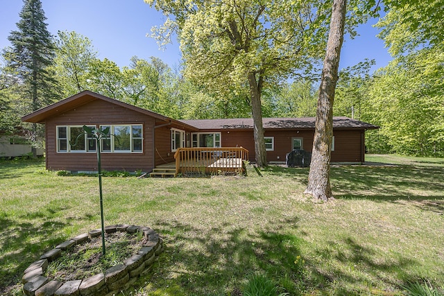224 Norman Point Rd NW, Longville, MN 56655 - back of house featuring a deck and a lawn