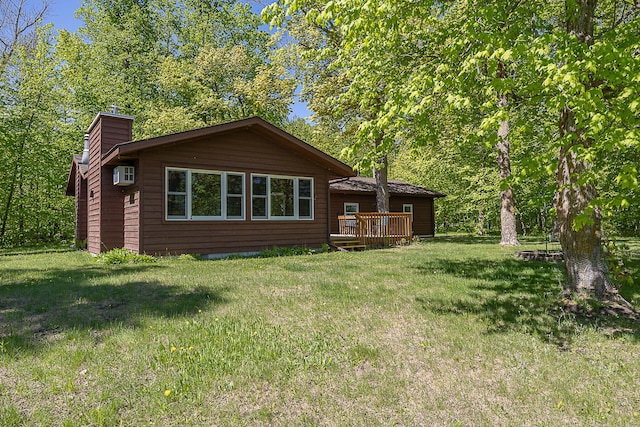 224 Norman Point Rd NW, Longville, MN 56655 - back of house with a chimney, a wooden deck, a yard, and an AC wall unit