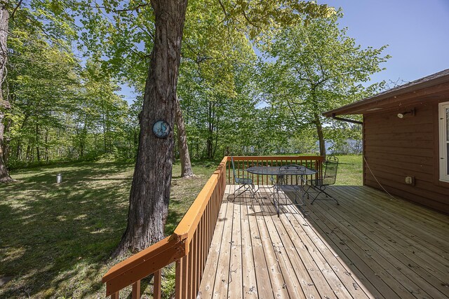 224 Norman Point Rd NW, Longville, MN 56655 - wooden terrace featuring outdoor dining space and a yard