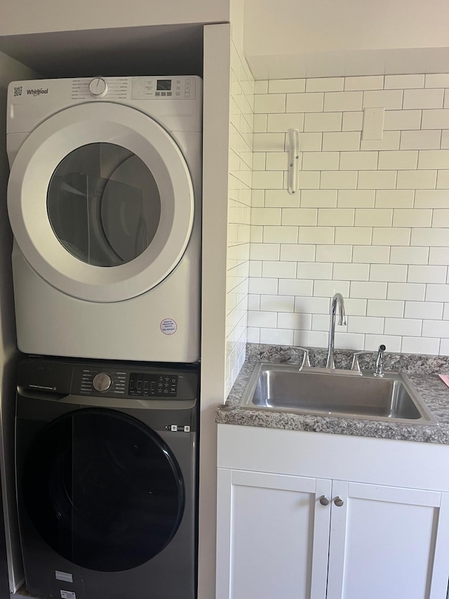 1030 28th Ave NE, Minneapolis, MN 55418 - washroom featuring stacked washer / dryer and a sink