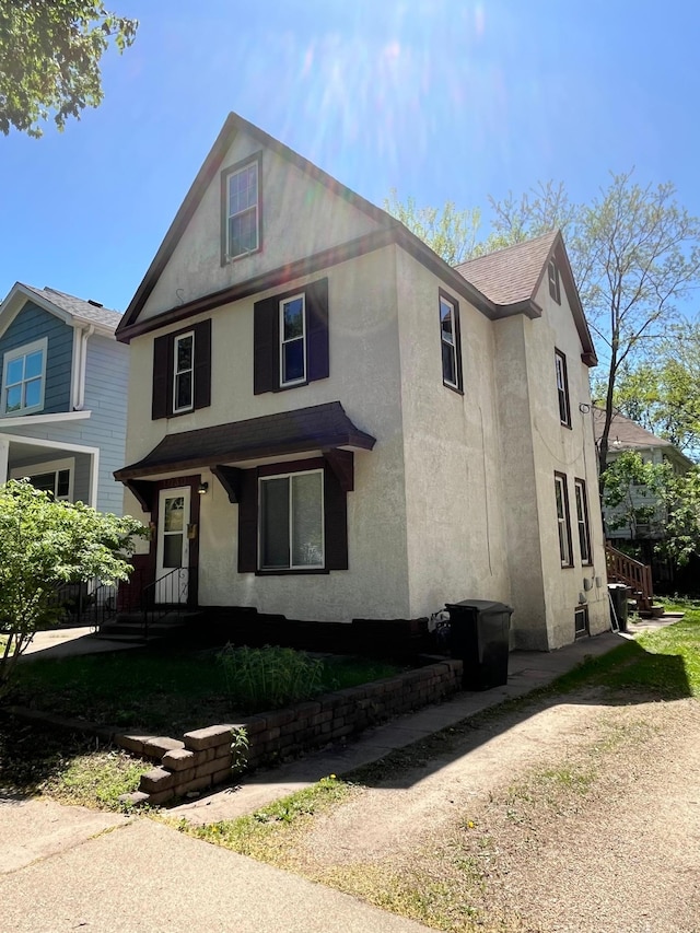 1030 28th Ave NE, Minneapolis, MN 55418 - view of front facade with stucco siding and roof with shingles