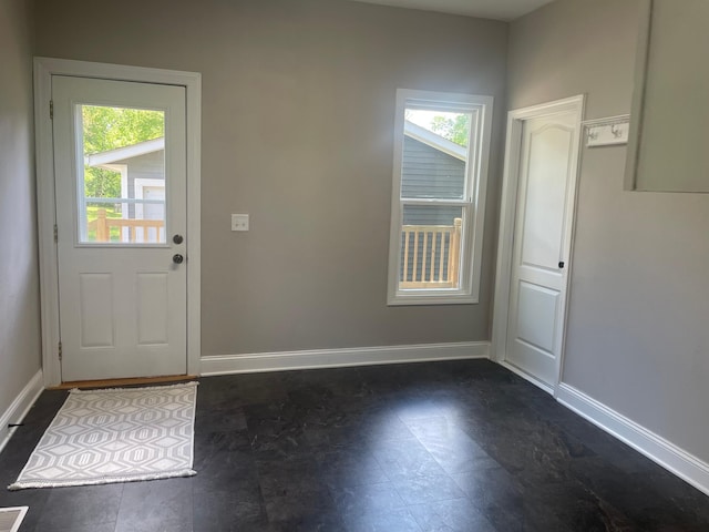 309 4th St, Marshall, MN 56258 - doorway to outside featuring baseboards