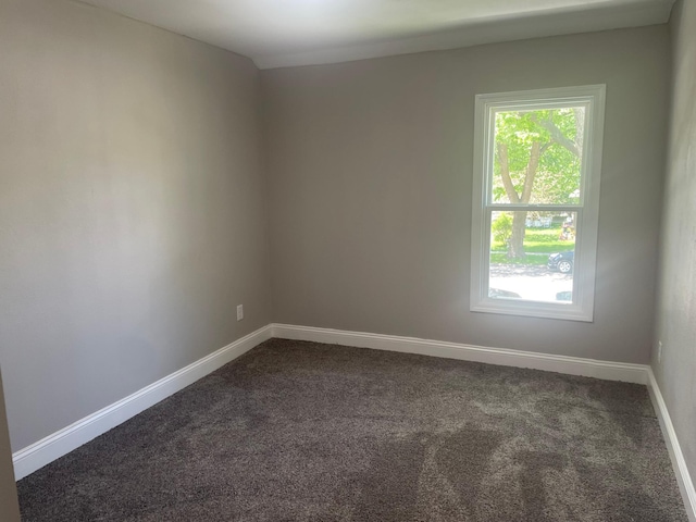 309 4th St, Marshall, MN 56258 - spare room with dark carpet, healthy amount of natural light, and baseboards