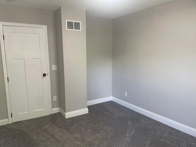 309 4th St, Marshall, MN 56258 - spare room featuring dark colored carpet and baseboards