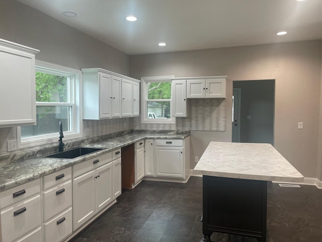 309 4th St, Marshall, MN 56258 - kitchen featuring a sink, white cabinets, plenty of natural light, and recessed lighting