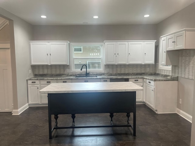 309 4th St, Marshall, MN 56258 - kitchen with a sink, white cabinets, backsplash, baseboards, and recessed lighting