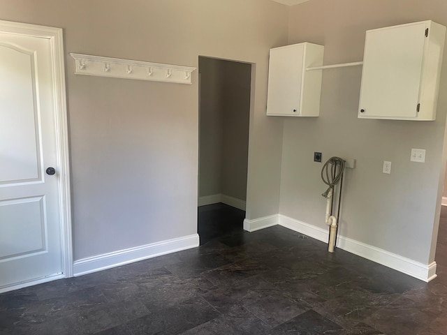 309 4th St, Marshall, MN 56258 - laundry room with cabinet space, dark stone finish floors, baseboards, hookup for an electric dryer, and hookup for a washing machine