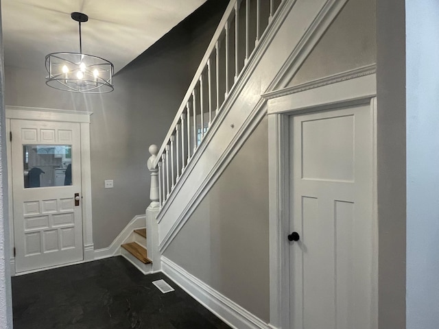 309 4th St, Marshall, MN 56258 - foyer featuring stairs, a chandelier, and baseboards