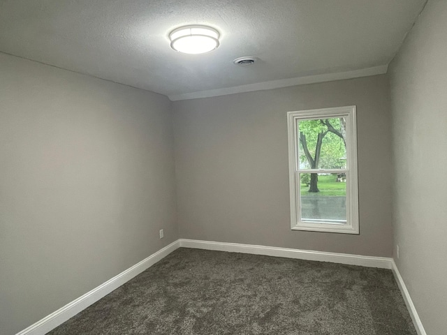 309 4th St, Marshall, MN 56258 - spare room featuring dark colored carpet, baseboards, and a textured ceiling