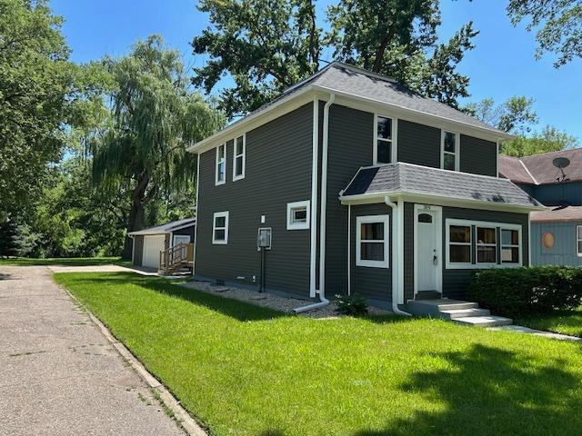 309 4th St, Marshall, MN 56258 - view of front of house with a front yard and an outdoor structure