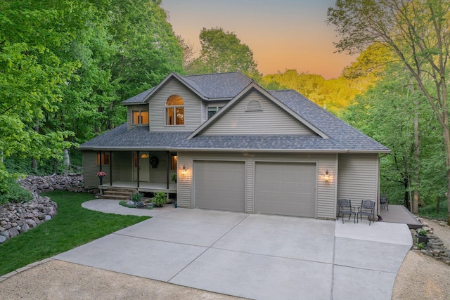 100 Hill Dr, Lime Twp, MN 56001 - view of front of property with a porch, an attached garage, concrete driveway, a shingled roof, and a front lawn