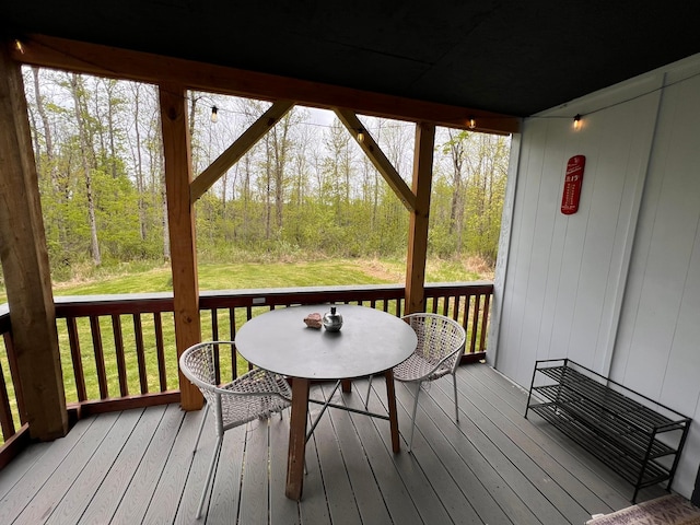 11216 State Highway 27, Beaver Twp, MN 55783 - wooden terrace with a yard, outdoor dining space, and a view of trees