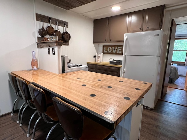 11216 State Highway 27, Beaver Twp, MN 55783 - kitchen with white appliances, butcher block countertops, dark wood finished floors, a peninsula, and recessed lighting