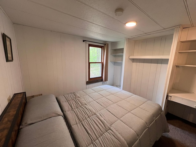 11216 State Highway 27, Beaver Twp, MN 55783 - bedroom featuring carpet floors and wood walls
