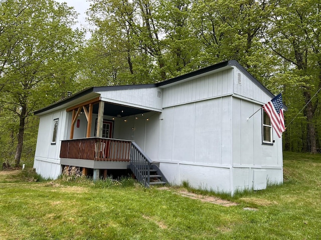 11216 State Highway 27, Beaver Twp, MN 55783 - back of house featuring a lawn, a porch, and view of wooded area