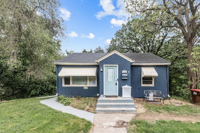 1560 Stickney Ave S, Saint Paul, MN 55075 - view of front of property featuring a front lawn, stucco siding, and roof with shingles